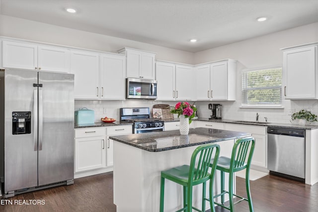 1171 Hampton Place Cir, Loudon, TN 37774 - kitchen with stainless steel appliances, dark wood-style flooring, white cabinetry, dark stone countertops, and recessed lighting