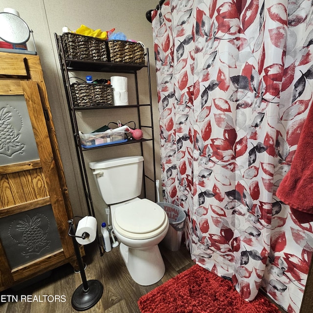 1911 Branam Hill Rd, Jellico, TN 37762 - full bathroom with wood finished floors and a shower with curtain