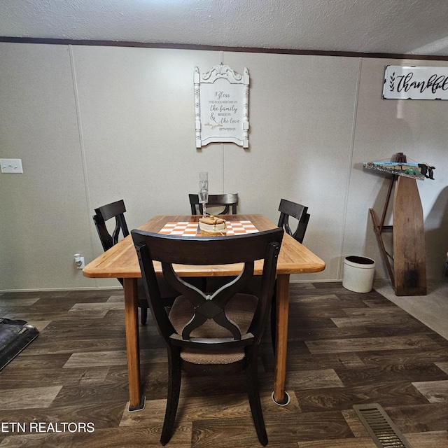1911 Branam Hill Rd, Jellico, TN 37762 - dining space with a textured ceiling and dark wood-style flooring