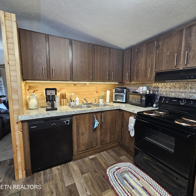 1911 Branam Hill Rd, Jellico, TN 37762 - kitchen featuring black appliances, range hood, light countertops, dark wood-type flooring, and a textured ceiling