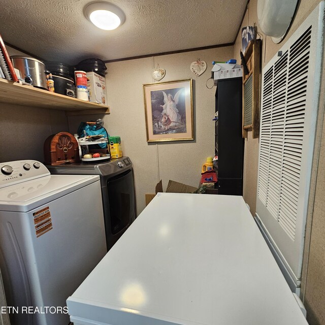 1911 Branam Hill Rd, Jellico, TN 37762 - washroom with washing machine and clothes dryer, a textured ceiling, and a heating unit