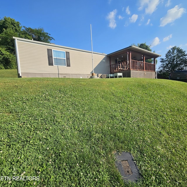 1911 Branam Hill Rd, Jellico, TN 37762 - back of house with a lawn and a deck