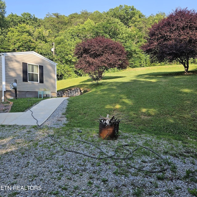 1911 Branam Hill Rd, Jellico, TN 37762 - view of green lawn featuring a wooded view