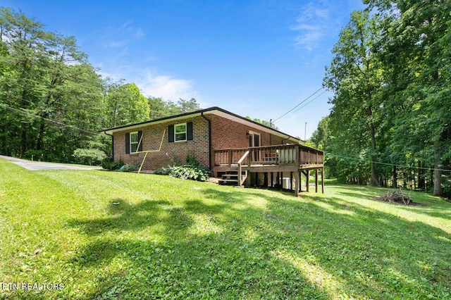 382 Tionesta Dr, Jacksboro, TN 37757 - back of property with brick siding, a wooden deck, and a lawn