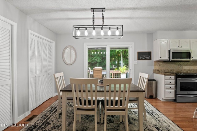 382 Tionesta Dr, Jacksboro, TN 37757 - dining space featuring wood finished floors and a textured ceiling