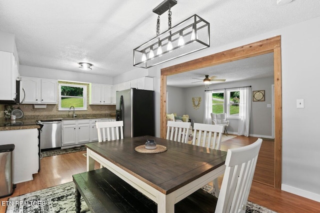 382 Tionesta Dr, Jacksboro, TN 37757 - dining room with plenty of natural light, a ceiling fan, dark wood-style flooring, and a textured ceiling