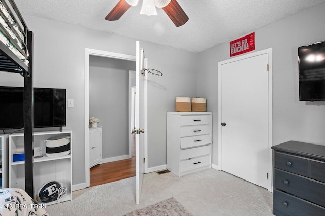 382 Tionesta Dr, Jacksboro, TN 37757 - bedroom with light carpet, a textured ceiling, and ceiling fan