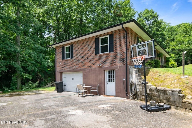 382 Tionesta Dr, Jacksboro, TN 37757 - view of front of house featuring brick siding, an attached garage, and asphalt driveway