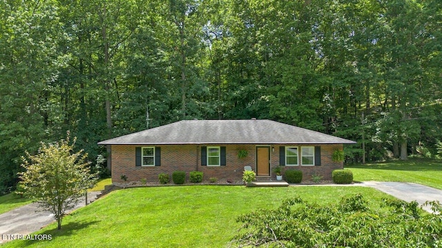 382 Tionesta Dr, Jacksboro, TN 37757 - single story home with brick siding, a front yard, and a shingled roof