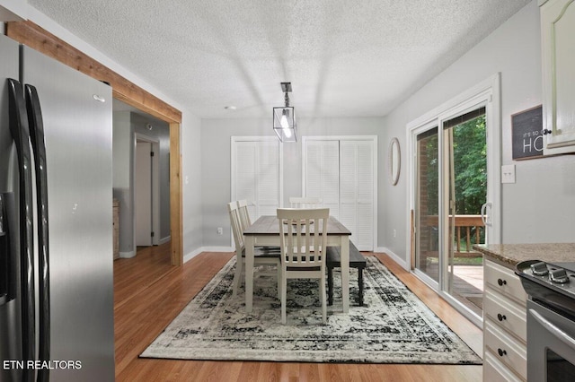 382 Tionesta Dr, Jacksboro, TN 37757 - dining room featuring light wood-style flooring and a textured ceiling