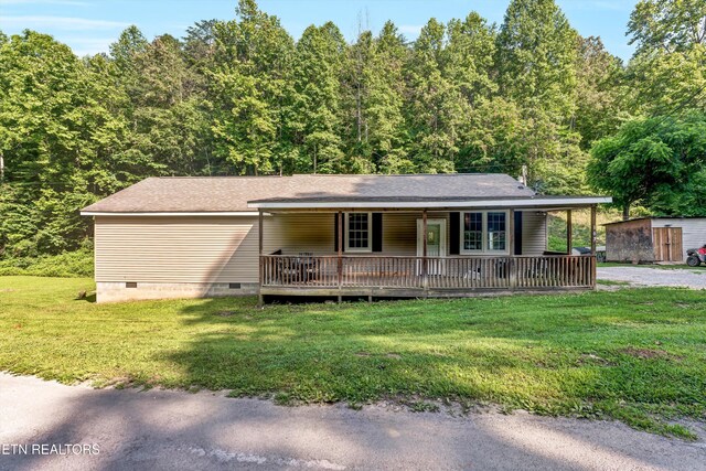 163 Ridge Rd, Sharps Chapel, TN 37866 - view of front of house with crawl space, a front yard, covered porch, a forest view, and a storage unit