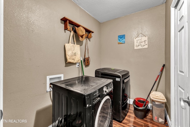163 Ridge Rd, Sharps Chapel, TN 37866 - washroom with washing machine and dryer, wood finished floors, a textured ceiling, and a textured wall