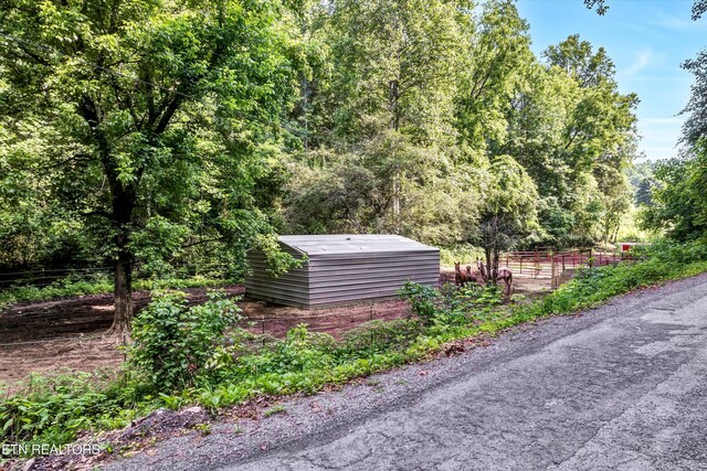 163 Ridge Rd, Sharps Chapel, TN 37866 - view of yard featuring a wooded view and a shed