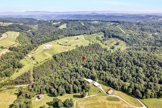 163 Ridge Rd, Sharps Chapel, TN 37866 - aerial view of property and surrounding area featuring a heavily wooded area and a mountain backdrop