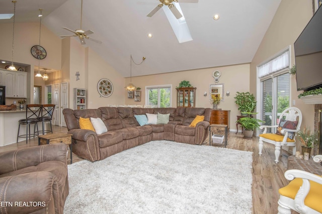 127 Kiowa Way, Loudon, TN 37774 - living room with high vaulted ceiling, a ceiling fan, light wood finished floors, a skylight, and recessed lighting