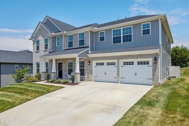 1682 Hickory Reserve Rd, Knoxville, TN 37932 - craftsman-style home with board and batten siding, covered porch, concrete driveway, an attached garage, and a front lawn