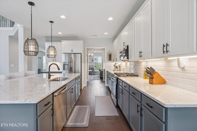 1682 Hickory Reserve Rd, Knoxville, TN 37932 - kitchen with appliances with stainless steel finishes, dark wood finished floors, backsplash, a spacious island, and white cabinetry