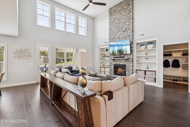 1682 Hickory Reserve Rd, Knoxville, TN 37932 - living room with a high ceiling, a stone fireplace, a ceiling fan, and dark wood-style flooring