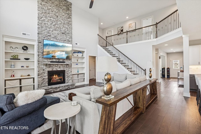 1682 Hickory Reserve Rd, Knoxville, TN 37932 - living room featuring a high ceiling, dark wood-type flooring, a fireplace, recessed lighting, and stairs