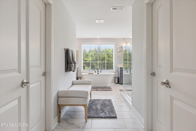 1682 Hickory Reserve Rd, Knoxville, TN 37932 - full bathroom featuring marble look tile flooring and a freestanding tub