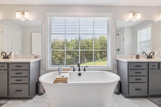 1682 Hickory Reserve Rd, Knoxville, TN 37932 - full bathroom featuring marble look tile flooring, healthy amount of natural light, and two vanities