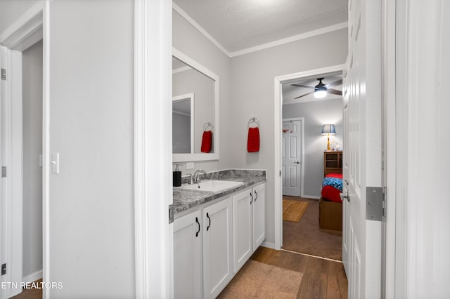238 Mac Ivey Ln, Lafollette, TN 37766 - bathroom with wood finished floors, vanity, ceiling fan, and crown molding