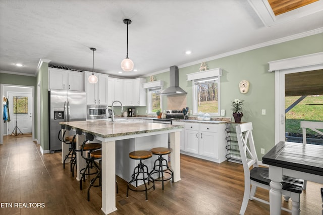 238 Mac Ivey Ln, Lafollette, TN 37766 - kitchen featuring stainless steel appliances, wall chimney exhaust hood, light stone counters, crown molding, and a kitchen breakfast bar