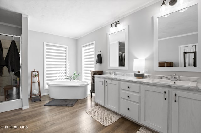 238 Mac Ivey Ln, Lafollette, TN 37766 - bathroom featuring double vanity, a shower stall, wood finished floors, a freestanding tub, and crown molding