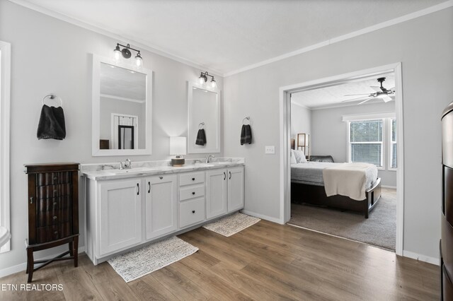 238 Mac Ivey Ln, Lafollette, TN 37766 - bathroom with double vanity, ornamental molding, connected bathroom, wood finished floors, and a ceiling fan