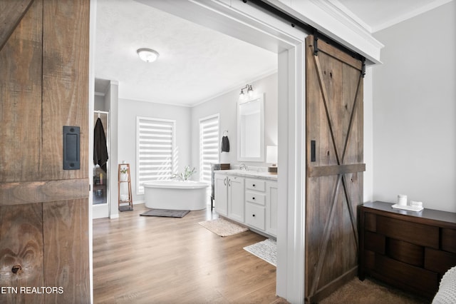 238 Mac Ivey Ln, Lafollette, TN 37766 - full bath with vanity, a freestanding bath, wood finished floors, and ornamental molding