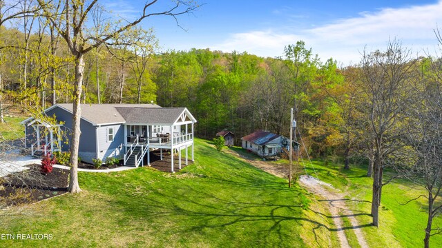 238 Mac Ivey Ln, Lafollette, TN 37766 - view of front of house with dirt driveway, a front lawn, stairs, a forest view, and a wooden deck