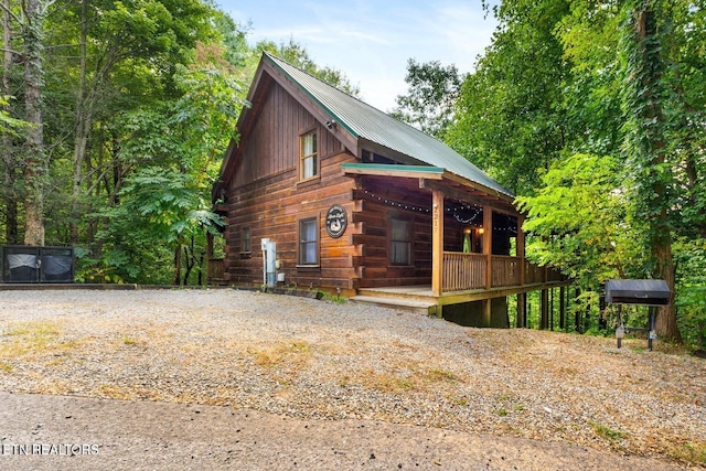 2217 Red Bud Rd, Sevierville, TN 37876 - view of front facade featuring a porch, a metal roof, and gravel driveway