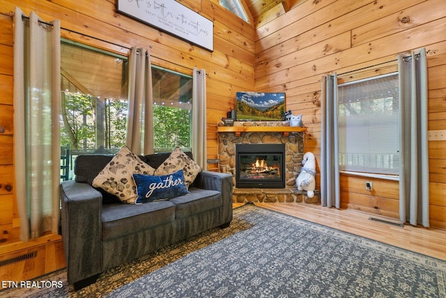 2217 Red Bud Rd, Sevierville, TN 37876 - living area featuring wood walls and a stone fireplace