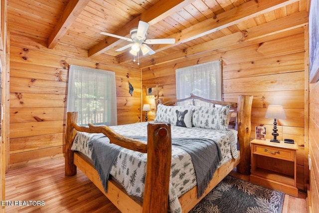 2217 Red Bud Rd, Sevierville, TN 37876 - bedroom featuring a wood ceiling with exposed beams, wood walls, wood finished floors, and a ceiling fan