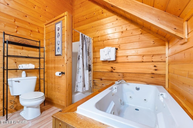 2217 Red Bud Rd, Sevierville, TN 37876 - bathroom featuring a whirlpool tub, wood walls, and wood finished floors