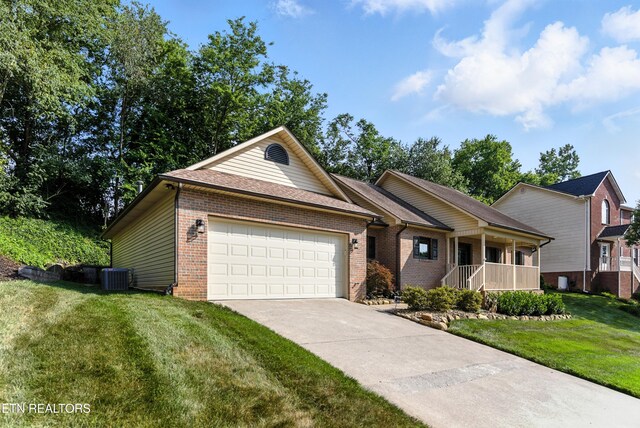 8808 Cedar Springs Ln, Knoxville, TN 37923 - single story home with brick siding, an attached garage, driveway, a front yard, and a porch