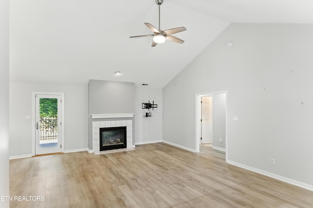 8808 Cedar Springs Ln, Knoxville, TN 37923 - unfurnished living room with a ceiling fan, a tile fireplace, high vaulted ceiling, and light wood-type flooring
