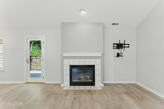 8808 Cedar Springs Ln, Knoxville, TN 37923 - unfurnished living room featuring wood finished floors and a tile fireplace