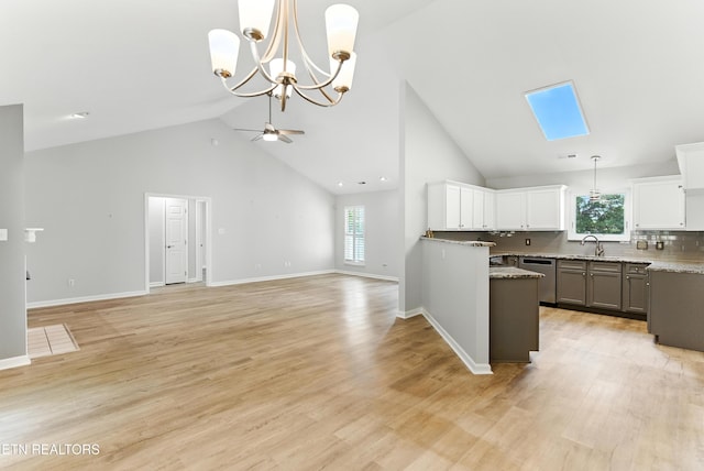 8808 Cedar Springs Ln, Knoxville, TN 37923 - kitchen with high vaulted ceiling, dishwasher, open floor plan, white cabinets, and decorative light fixtures
