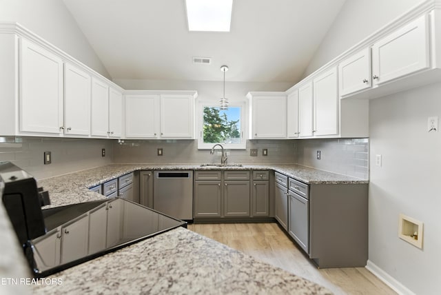 8808 Cedar Springs Ln, Knoxville, TN 37923 - kitchen with dishwasher, vaulted ceiling, light wood-style floors, tasteful backsplash, and white cabinetry