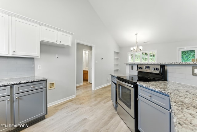 8808 Cedar Springs Ln, Knoxville, TN 37923 - kitchen with electric stove, a chandelier, white cabinets, tasteful backsplash, and high vaulted ceiling