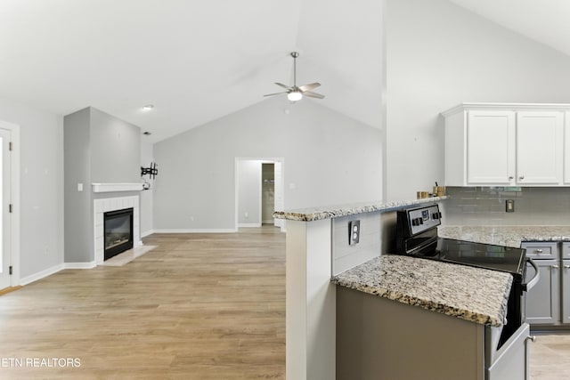 8808 Cedar Springs Ln, Knoxville, TN 37923 - kitchen with range with electric cooktop, lofted ceiling, ceiling fan, open floor plan, and backsplash