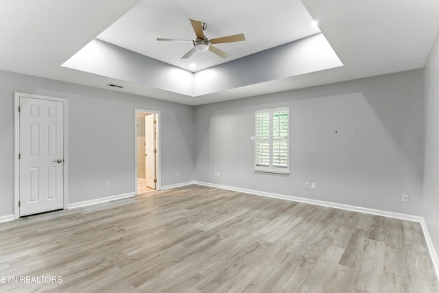 8808 Cedar Springs Ln, Knoxville, TN 37923 - empty room featuring ceiling fan, a raised ceiling, light wood-style floors, a skylight, and recessed lighting