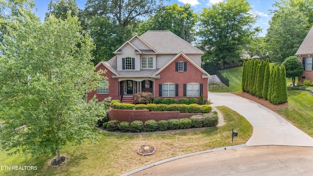 1269 Bentley Park Ln, Knoxville, TN 37922 - view of front facade featuring driveway, brick siding, and a front lawn