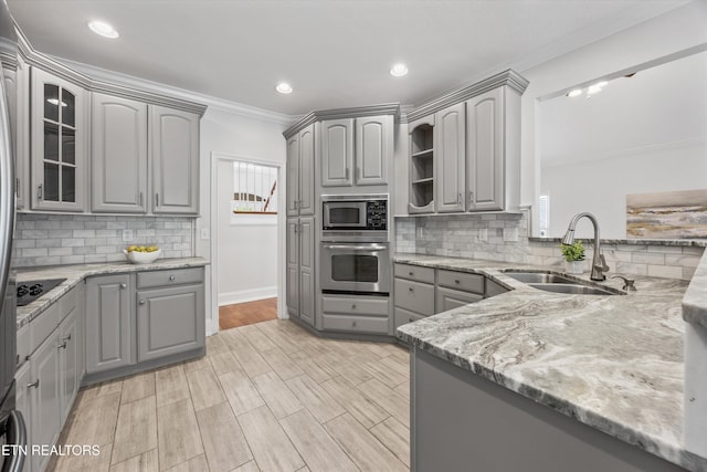1269 Bentley Park Ln, Knoxville, TN 37922 - kitchen featuring gray cabinetry, appliances with stainless steel finishes, ornamental molding, light stone counters, and plenty of natural light