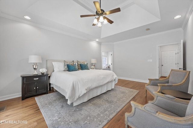 1269 Bentley Park Ln, Knoxville, TN 37922 - bedroom featuring a tray ceiling, recessed lighting, light wood-type flooring, ornamental molding, and a ceiling fan