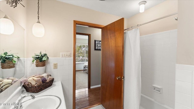 300 Clearfield Rd, Knoxville, TN 37922 - bathroom with wood finished floors, shower / bath combo with shower curtain, tile walls, and a wainscoted wall