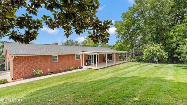 300 Clearfield Rd, Knoxville, TN 37922 - back of property with brick siding, a chimney, a yard, and a patio area