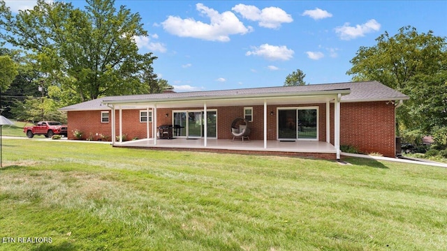 300 Clearfield Rd, Knoxville, TN 37922 - rear view of house with brick siding, a patio area, and a yard