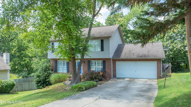 1517 Randal Park Dr, Knoxville, TN 37922 - colonial-style house with brick siding, concrete driveway, an attached garage, and roof with shingles